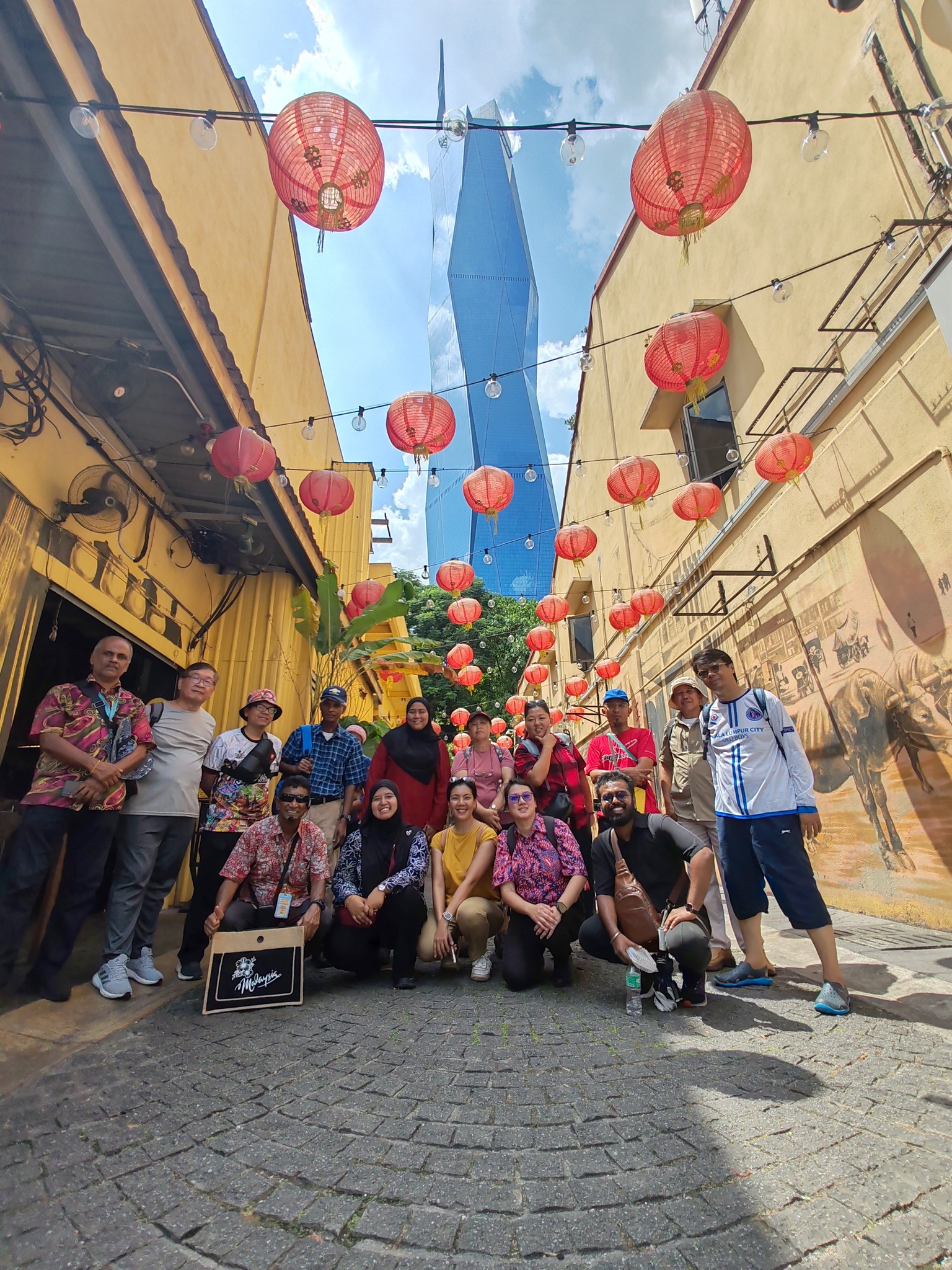 Professional tour guide showing tourists around Malaysia